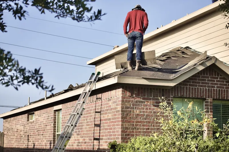 Professional roofer working on a residential roof in North Chelmsford